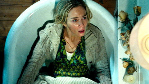 Emily Blunt looking distressed in a bathtub